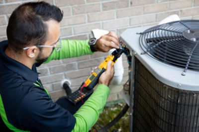 ac repair technician working on system