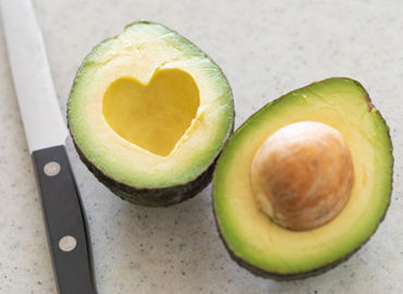 Sliced avocado with a heart-shaped hole.