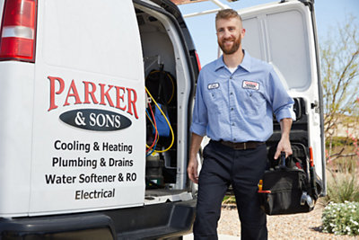 Parker & Sons tech entering a home with tool bag 