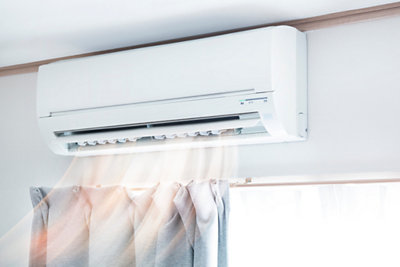 ductless air conditioning unit above window in home