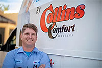 Technician standing in front of van displaying the Collins Comfort logo