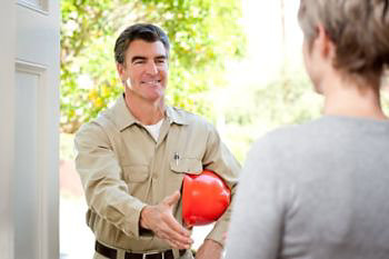 Technician handshaking with customer