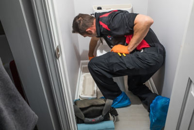  Plumber fixing a leaking toilet