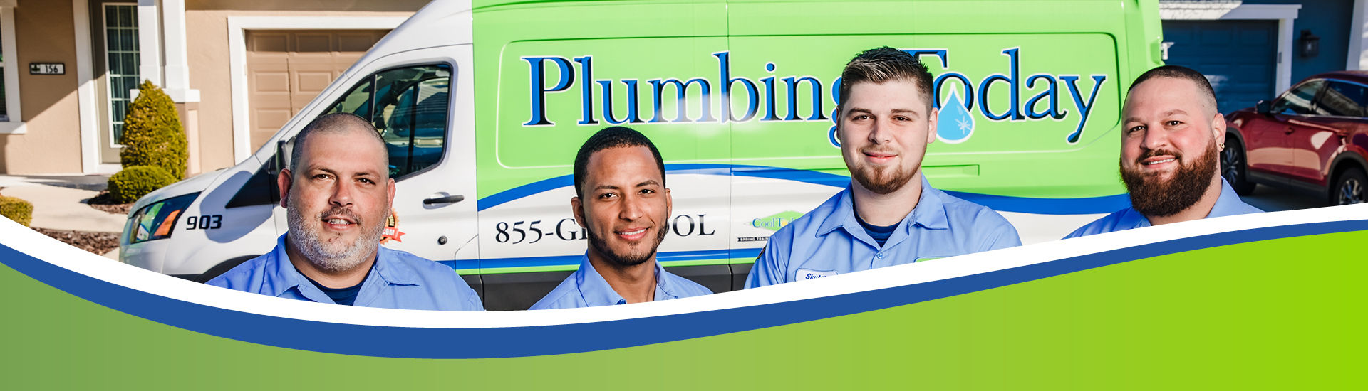 Plumbers in front of a service vehicle