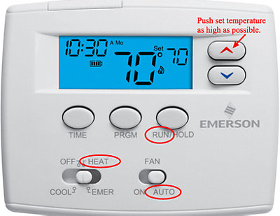White thermostat with red arrow pointing at high temp setting