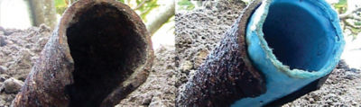Rusty and cracked cast iron pipe with new trenchless liner