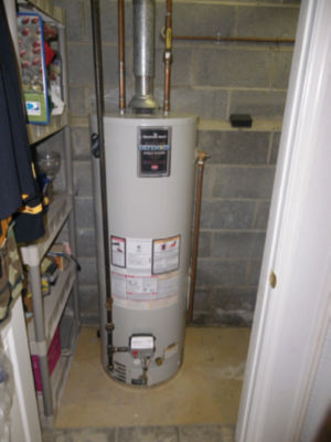 Water heater in closet with cinder block wall