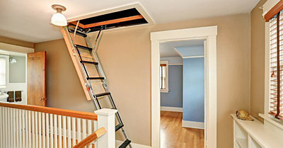 A ladder leading into an attic inside of a home.