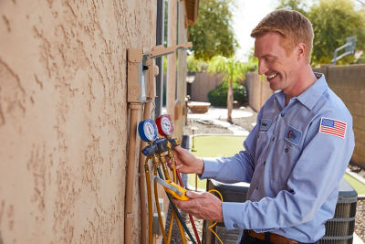 HVAC professional in Phoenix running a diagnostic on a new AC system