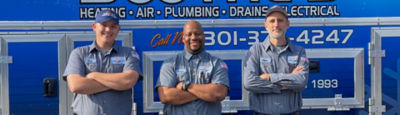 three techs posed in front of service truck 