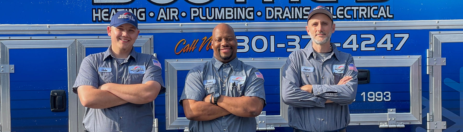 three techs posed in front of service truck 