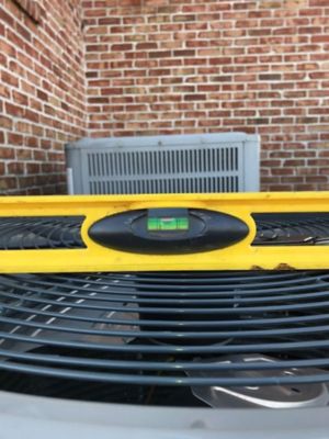 A yellow level on a black metal surface