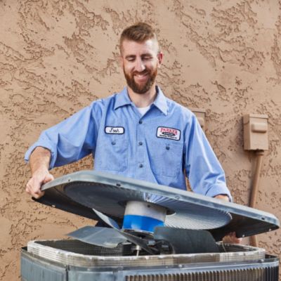 man-preforming-ac-tune-up-on-hvac-system