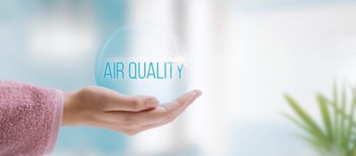 Hand holding a bubble of clean air in the bathroom, air quality concept