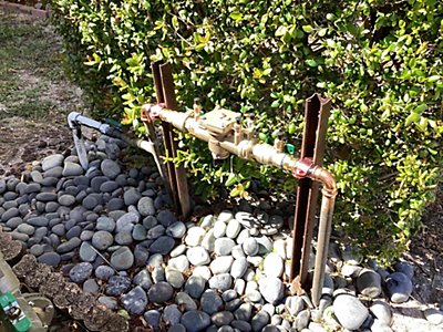 A jet pump connected to a hose and water pump without a backflow preventer