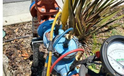 commercial backflow preventer being tested by Lindstrom plumber