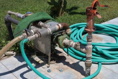 A jet pump connected to a hose and water pump without a backflow preventer