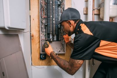 Electrician working on an electric panel in Lawrenceville