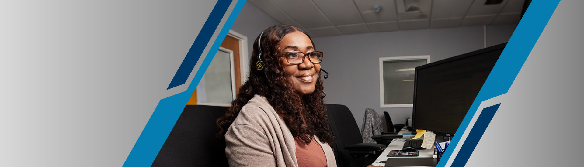 a person wearing a headset and sitting at a desk