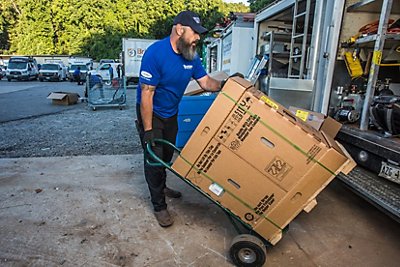 AC Installer Loading Box with Unit Into Coolray Truck