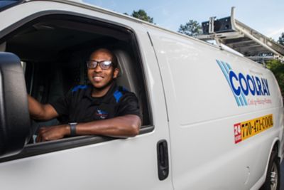 Coolray technician smiling in front of van