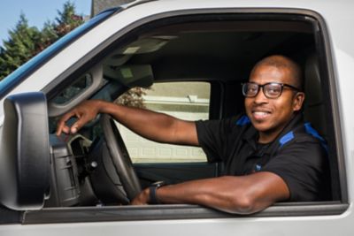 Coolray technician smiling in front of van