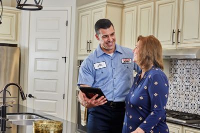 tech showing homeowner list on tablet