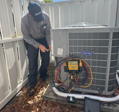 Lindstrom HVAC technician working on a Carrier unit