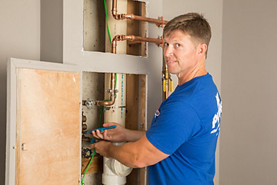 Plumber providing plumbing service in a home