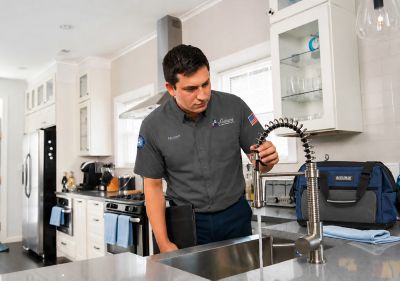 Tech looking at faucet for water quality