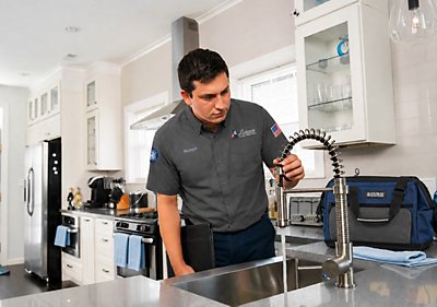 Tech looking at faucet for water quality