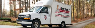 Plumber consulting with customer while looking under sink