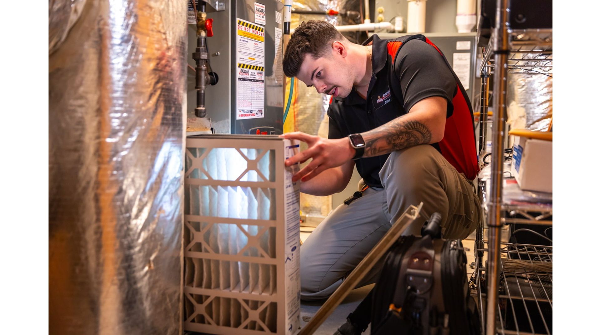 HVAC technician inspecting furnace with flashlight