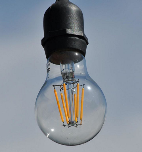 A light bulb with a black cap
