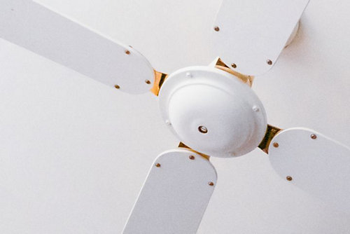 A white ceiling fan with four blades