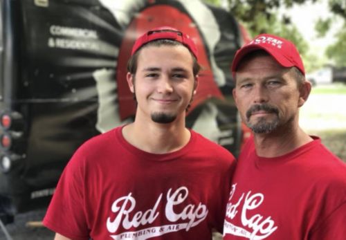 two men wearing red shirts 