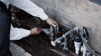 NEXGEN leak detection plumber holding a wrench