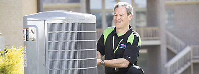 Technician working on an air conditioner or heat pump - Williams Comfort Air Heating, Cooling, Plumbing & More