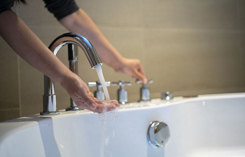 A person washing their hands 