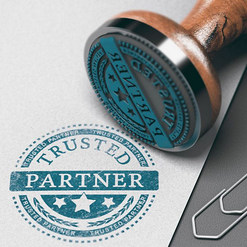 A Trusted Partner blue stamp on paper next to a paperclip