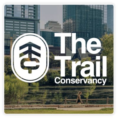 The Trail Conservancy logo with a person walking in the distance.