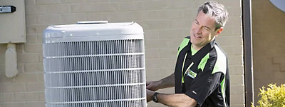 Close Up of Technician working on an air conditioner - Thomas & Galbraith Heating, Cooling, & Plumbing