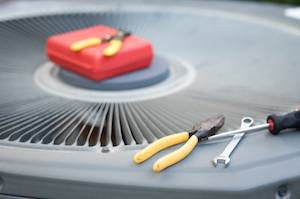Tools sitting on top of air conditioning unit