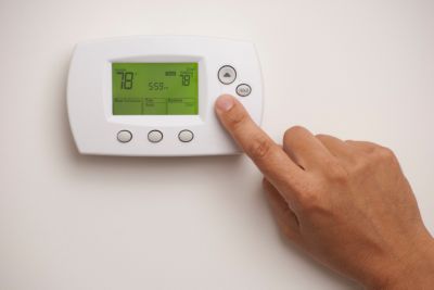 Digital Thermostat with a male hand, set to 78 degrees Fahrenheit. Saved with clipping path for thermostat and hand combined.