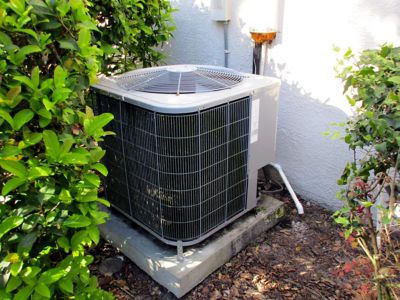 AC Unit Outside a White stucco house