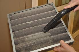 A technician cleaning an air filter.