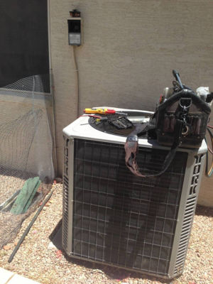 Air conditioning unit with tools sitting on top