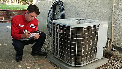 Technician Inspecting Air Conditioning Machine