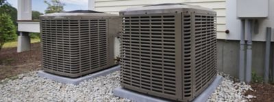 a couple of air conditioning units outside of a house