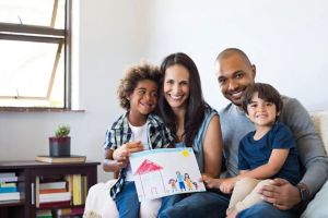 Family of four smiling for camera